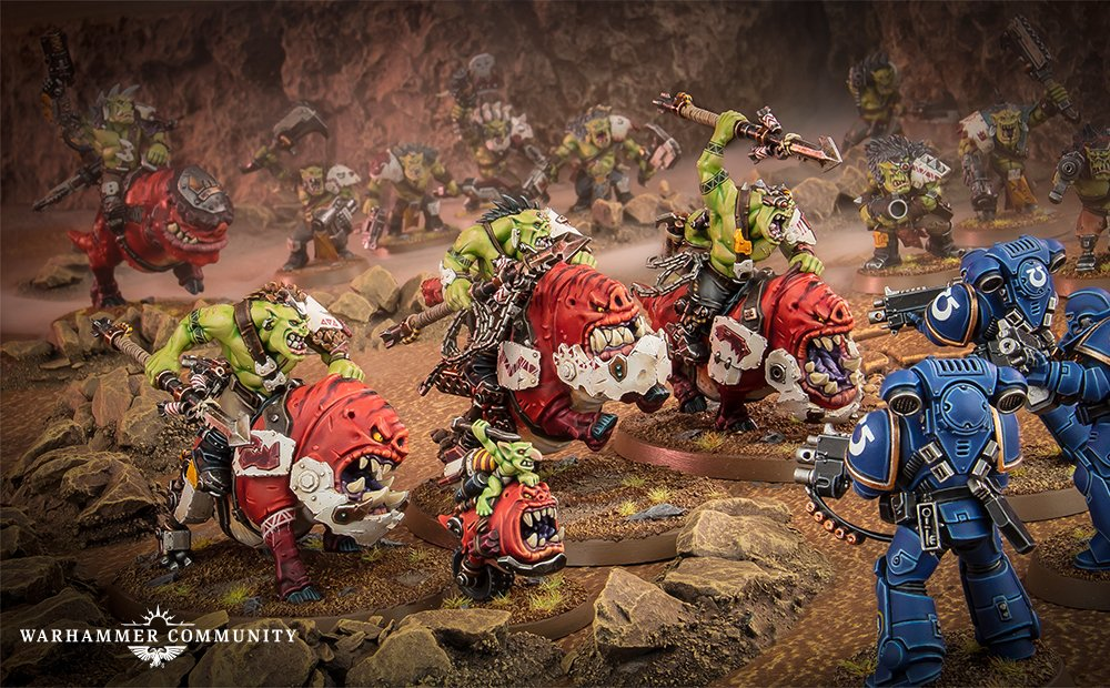 Beast Snagga Ork's riding squiggs and wielding spears charge a unit of space marines