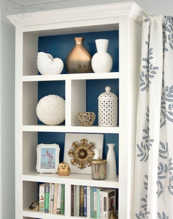Increase visibility of displayed items by painting the back of the bookcase. 