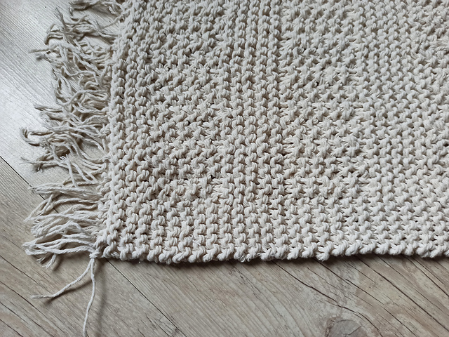 cream knit rug on floor