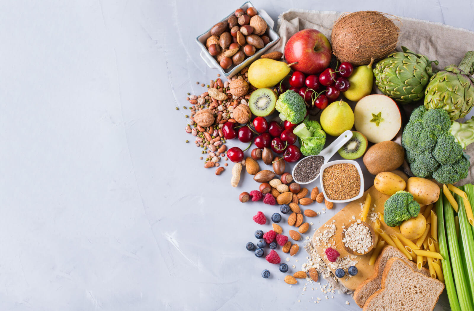 Selection of rich fibre sources of vegetables, fruits, grains, and bread.