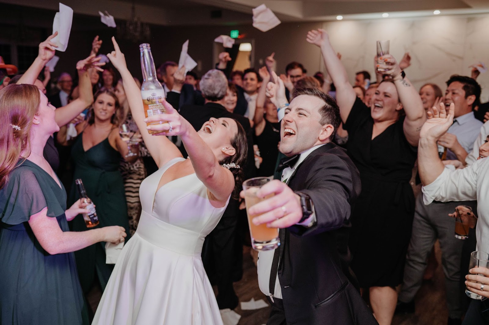 Happy couple dancing and singing at their wedding reception.