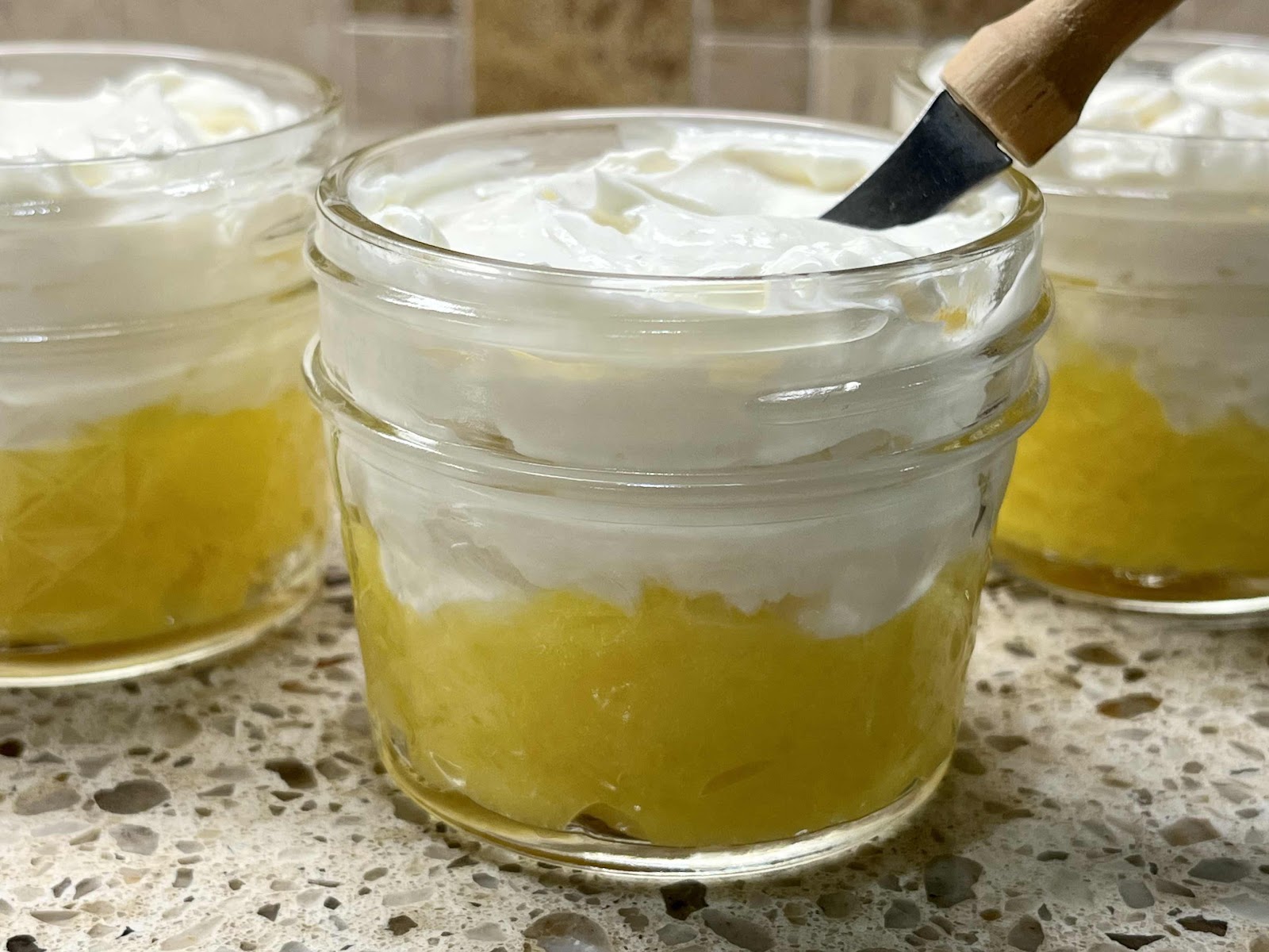 Place lemon curd on the bottom and top with the goat cheese