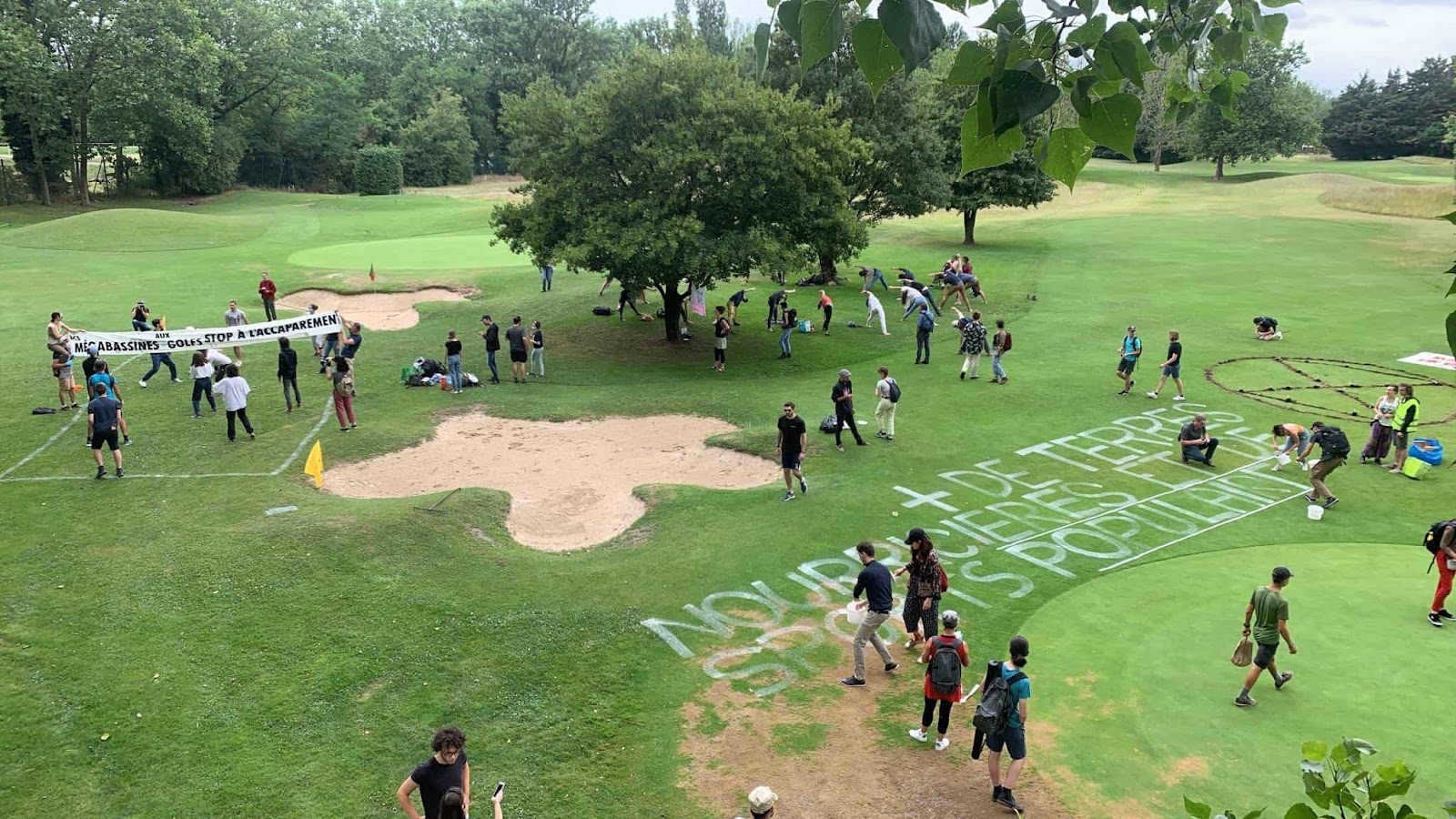 Rebels spray messages on the golf course grass and do yoga