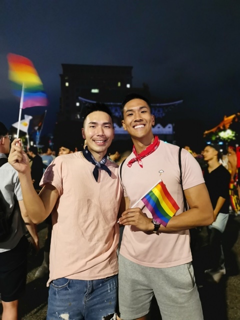 Andee Chua and his partner attending a Pride event with lots of LGBTQ+ folks.