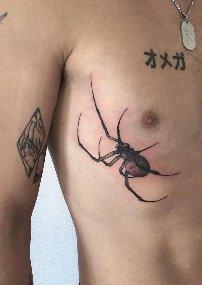 Close up view of a guy rocking the spider tat on his chest