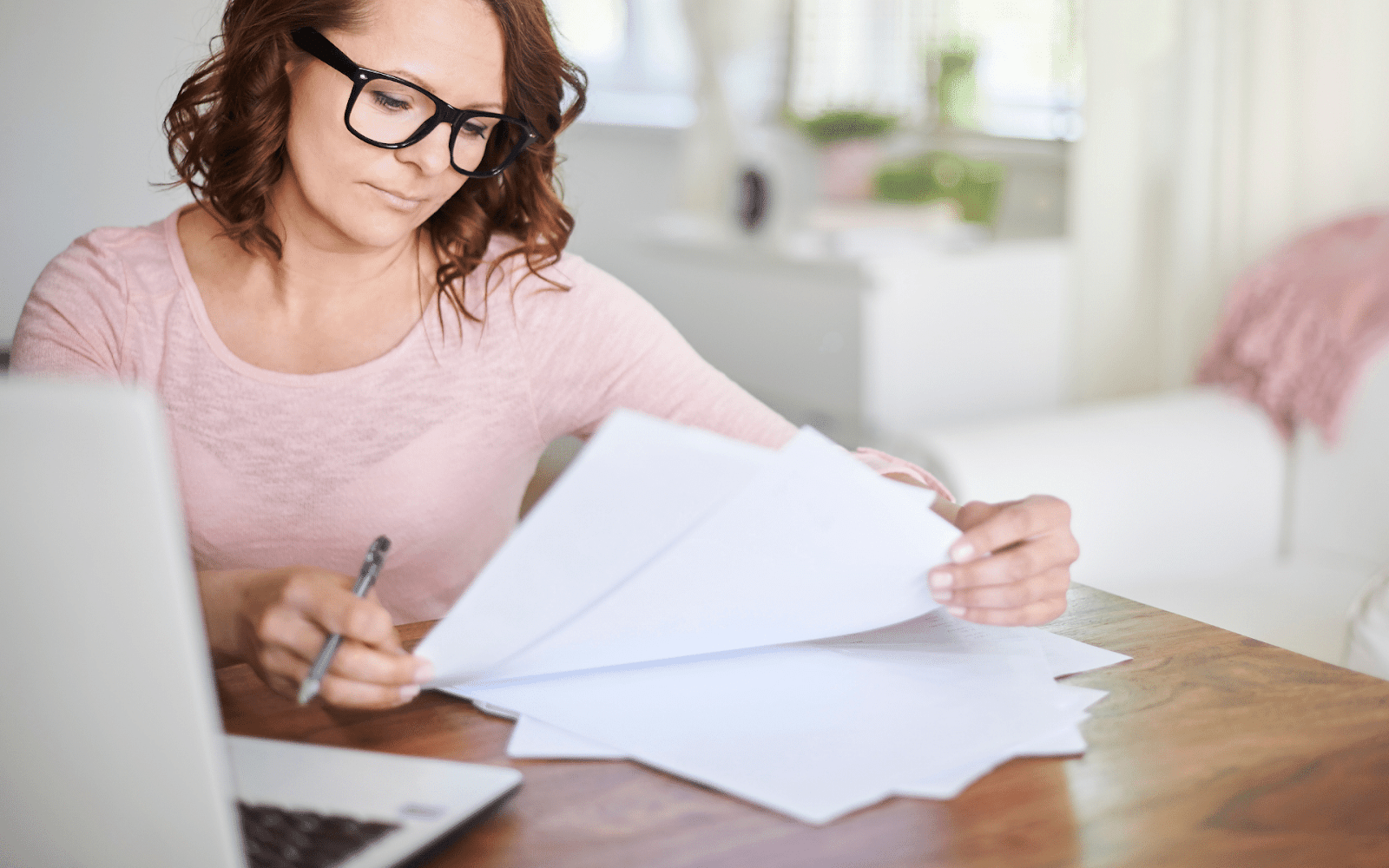 A person writing on a piece of paper

Description automatically generated with medium confidence