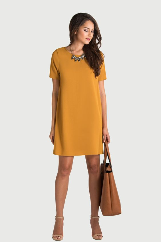 a lady wearing a brownish-yellow dress with short sleeves