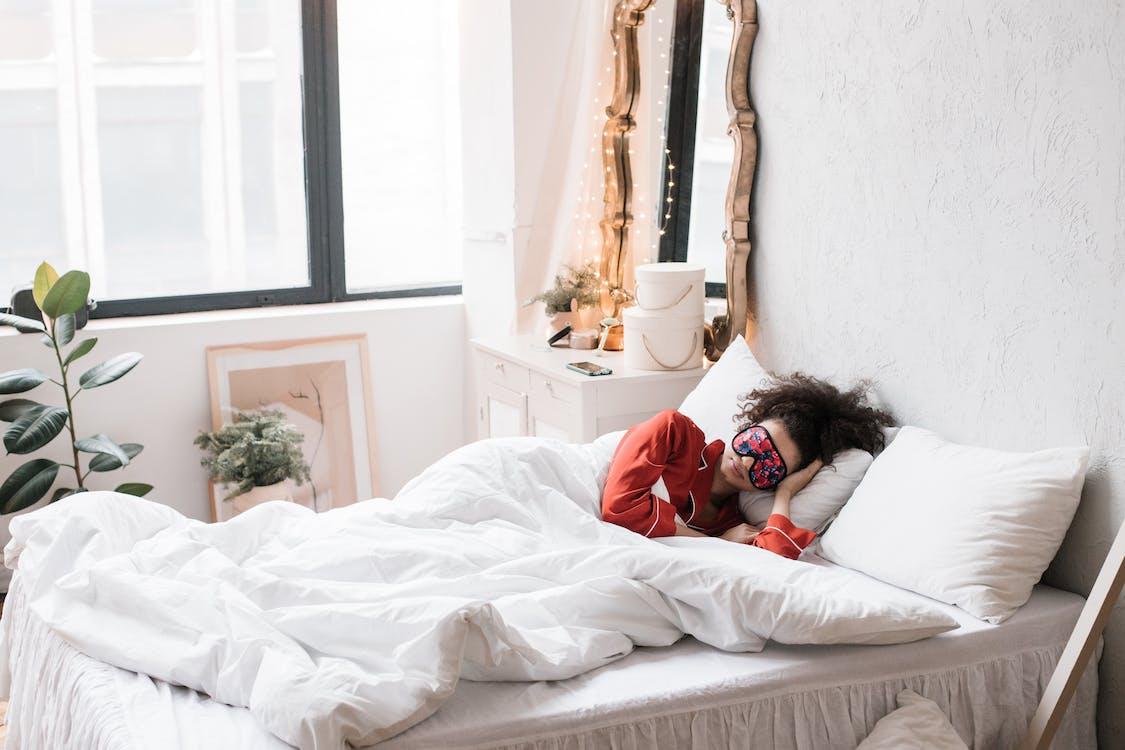 Free Woman Sleeping on a Bed Stock Photo