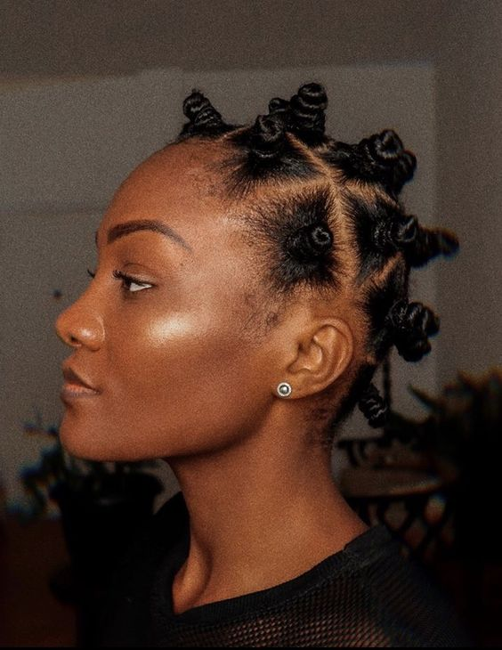 a cute lady wearing bantu knots for styling natural short hair