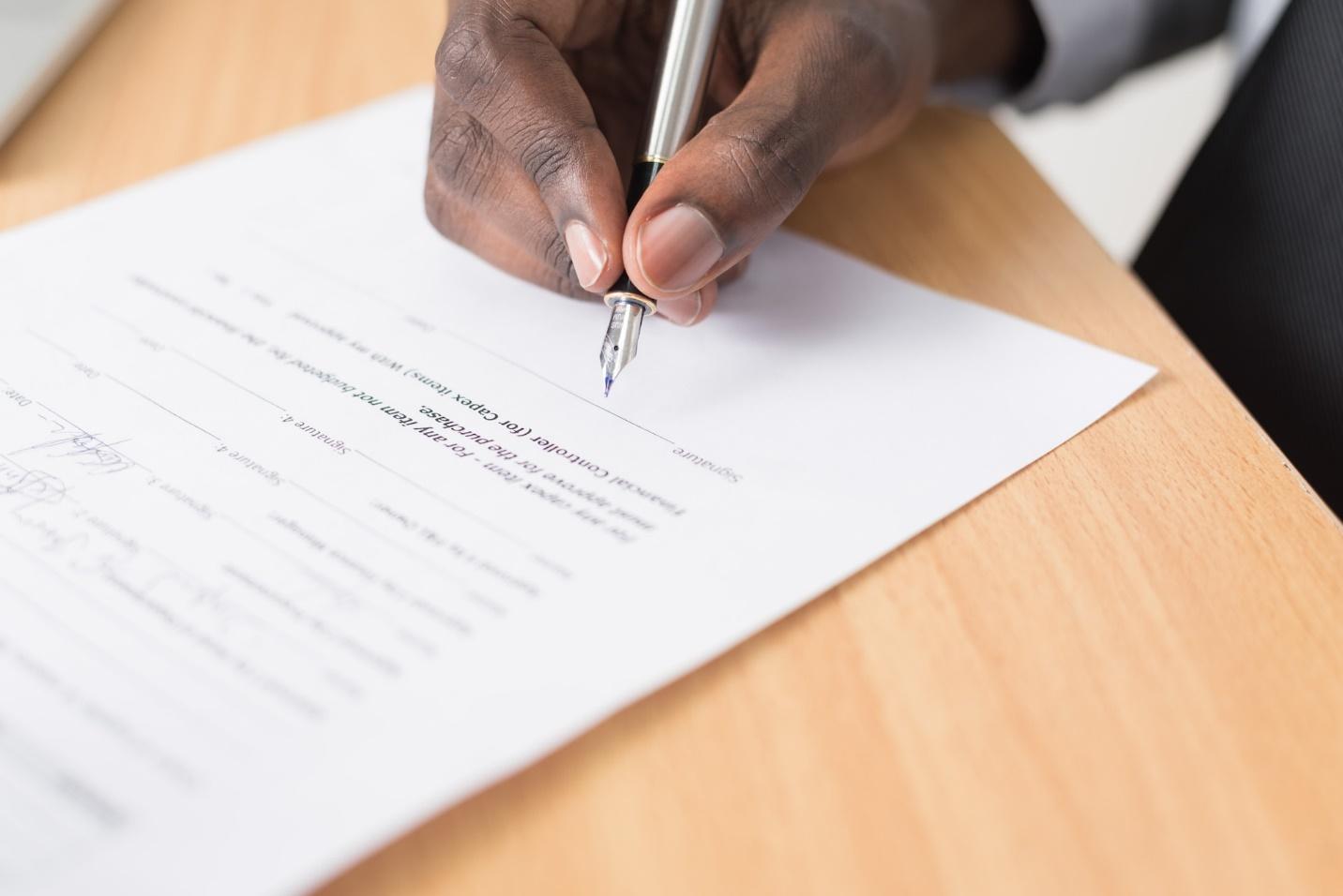 A business person signing a legal document