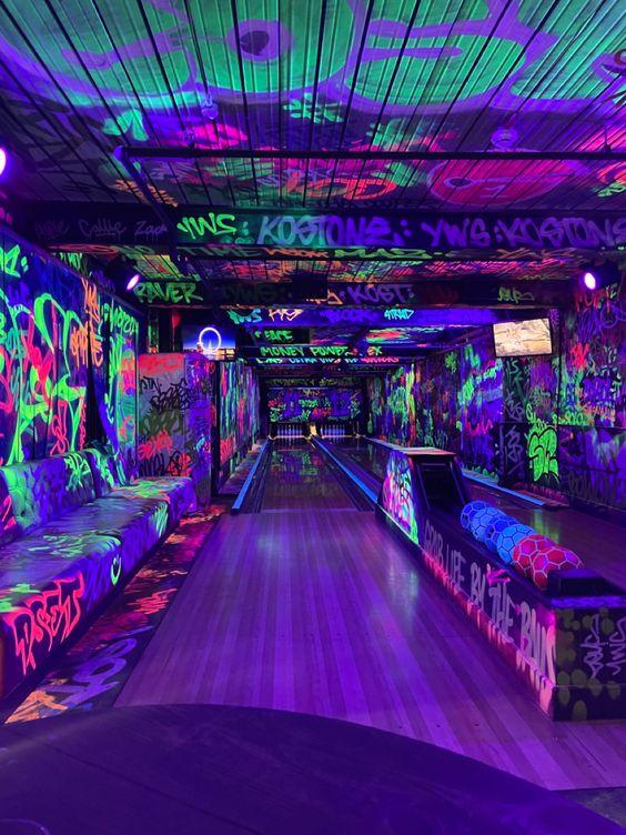 A bowling alley with neon lights

Description automatically generated
