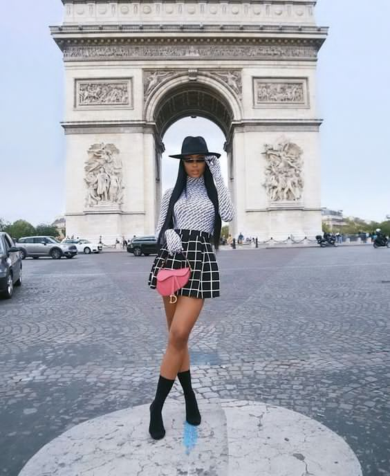 lady wearing stylish top and mini skirt and hat