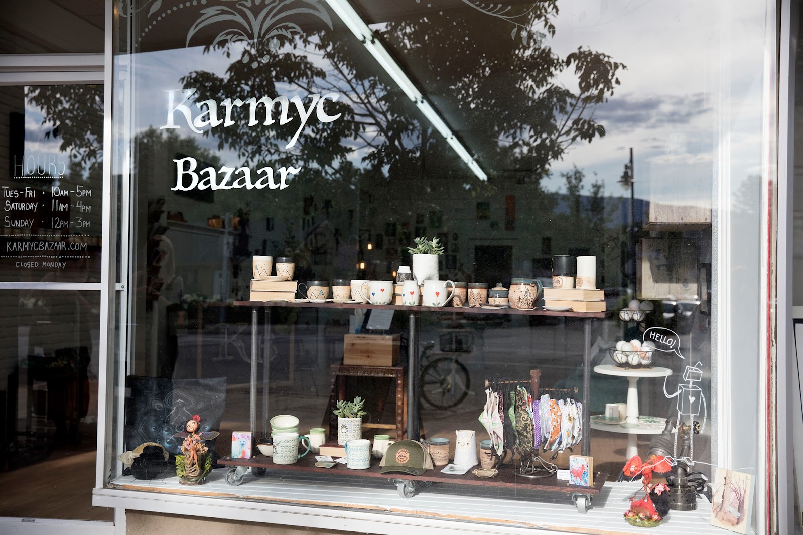 A front window view of Karmyc Bazaar, with local gifts and art treasures seen through the window