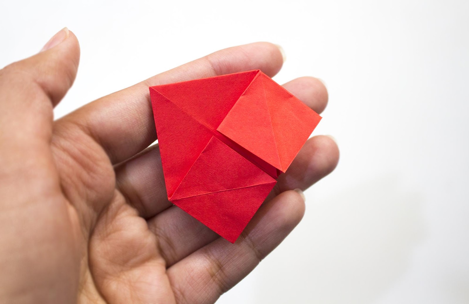 Red paper in the shape of a house from another angle