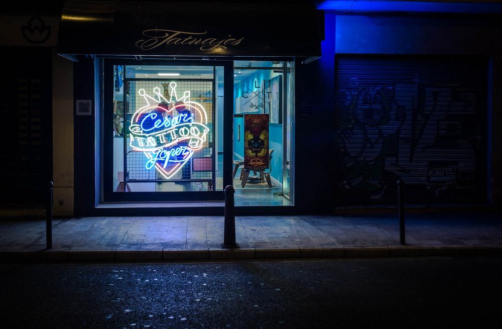 landscape photography of neon tattoo sign during nighttime