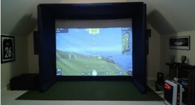 fully-built golf simulator with side padding, an enclosure and a hitting mat