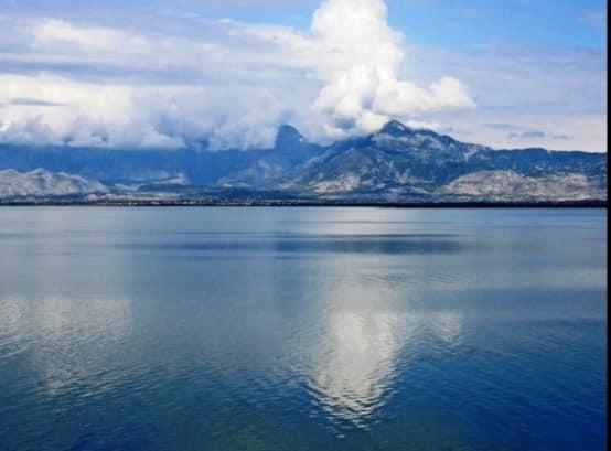 May be an image of lake, mountain, nature and sky