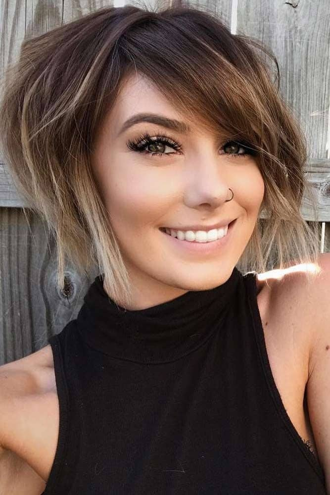 smiling lady wearing short layering hair