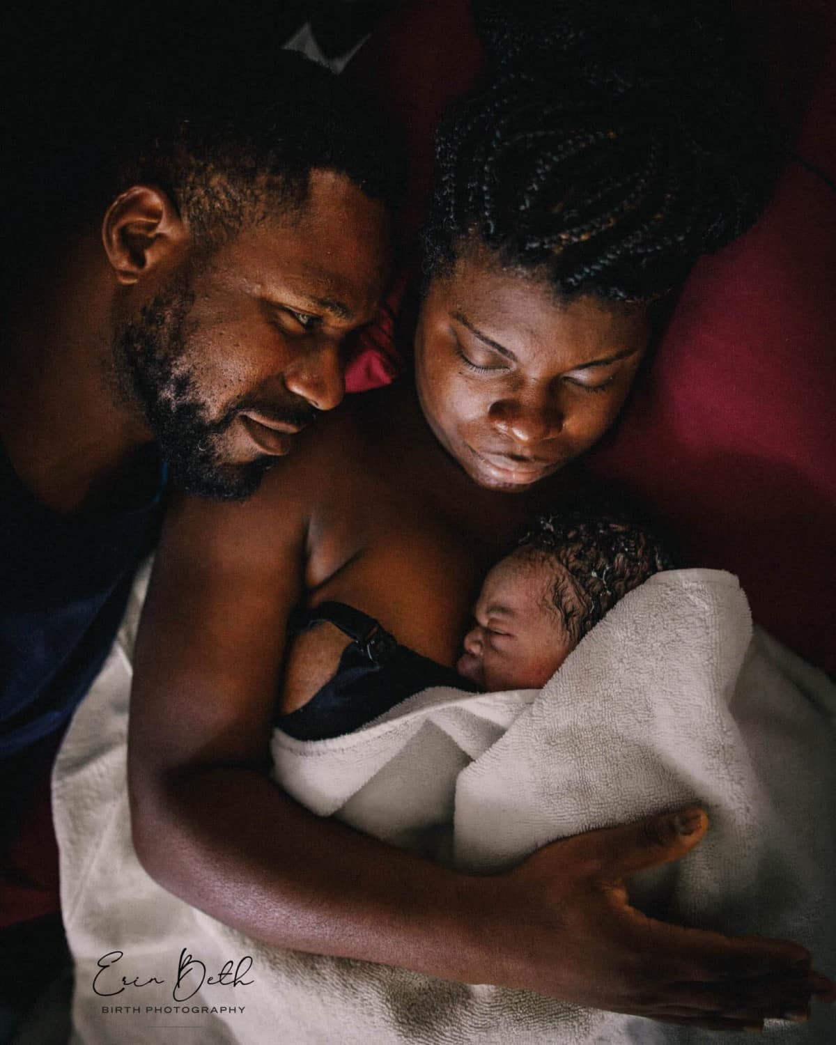 Family nestled together after birth of child