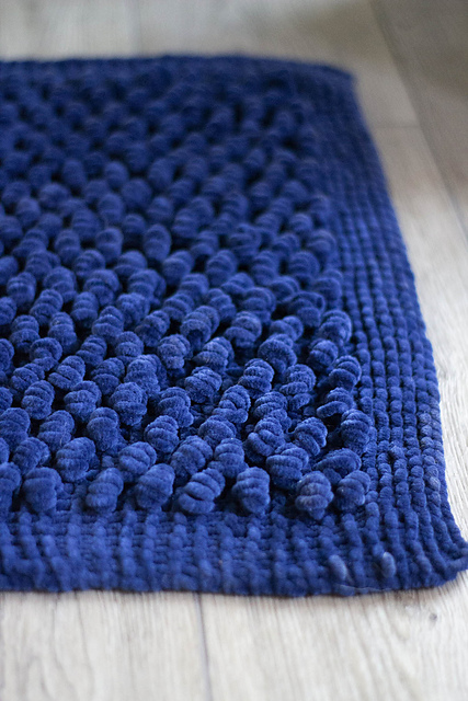 blue chenille rug on floor