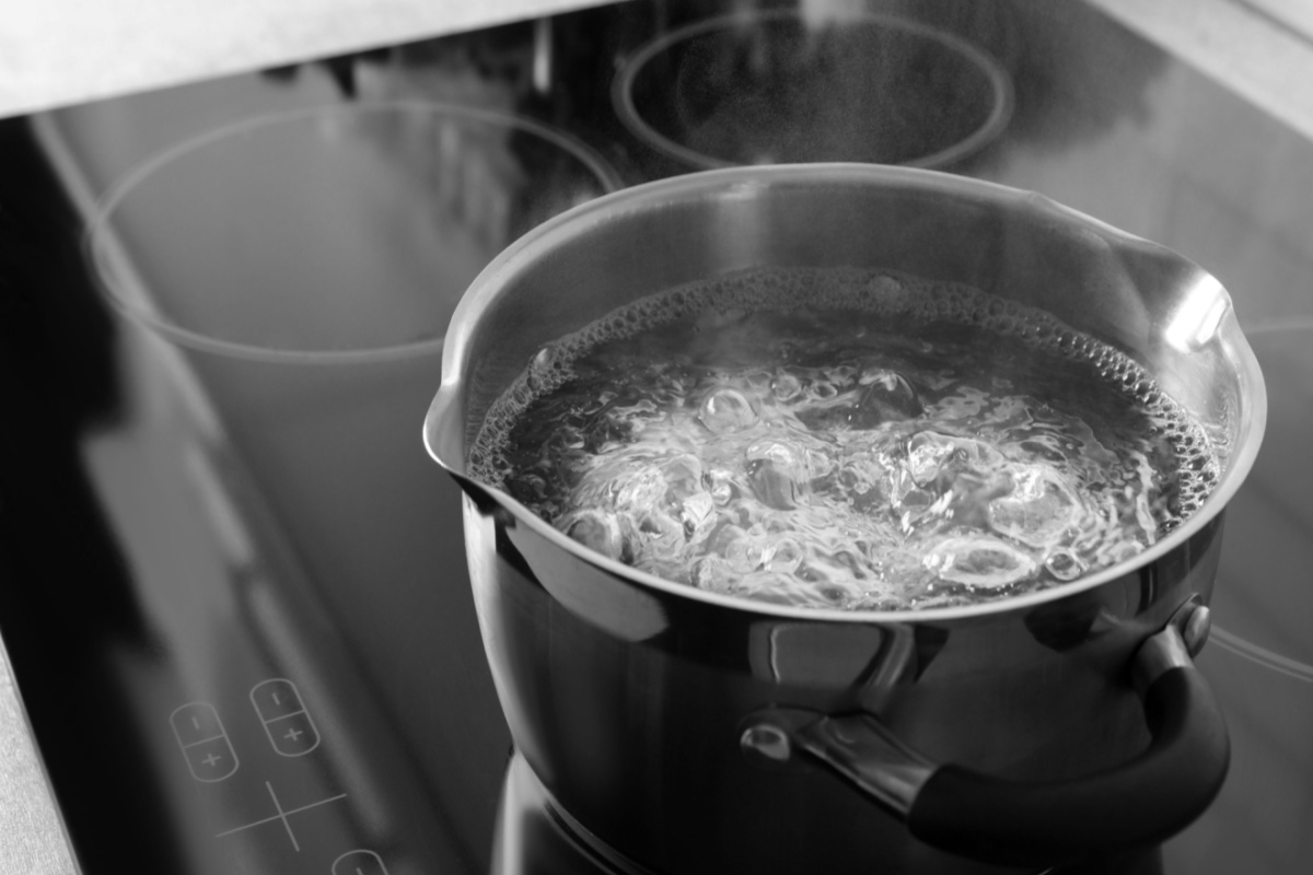 A pot of water boiling on a stove.