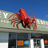 the big rock lobster is a lobster sculpture on top of a restaurant 