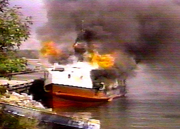 A boat on fire in water

Description automatically generated