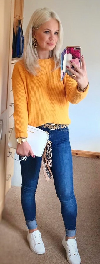 Yellow knitted sweater and blue jeans