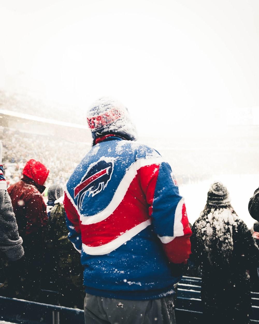 people in winter jackets standing on snow covered ground during daytime