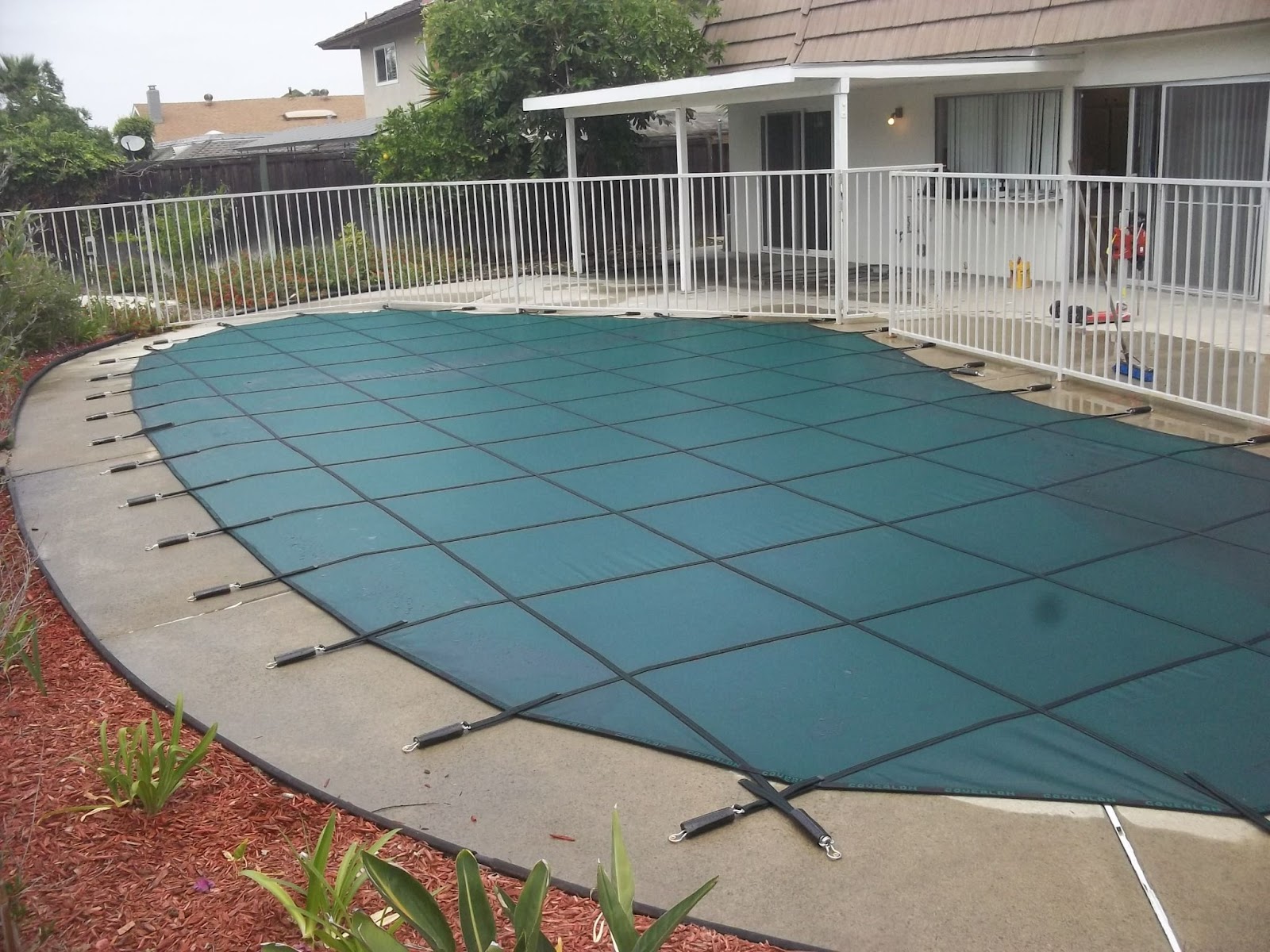 Swimming Pool Cover installed on a backyard pool
