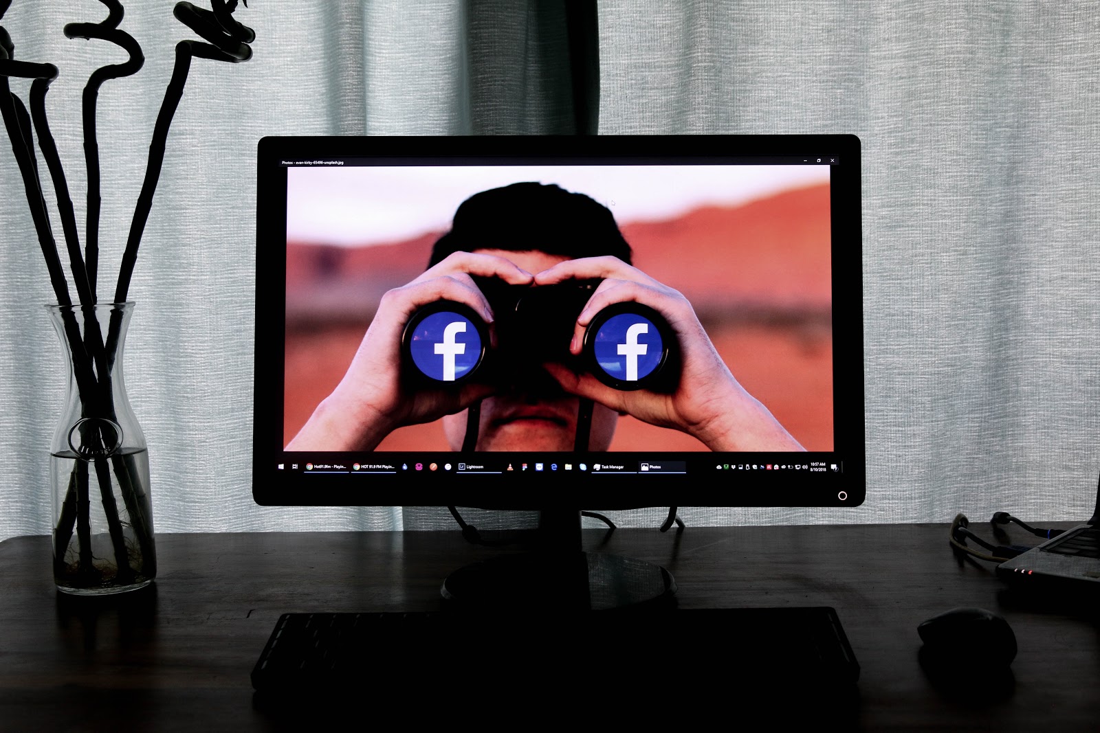 Man using binoculars with Facebook logo which include app store optimization trends