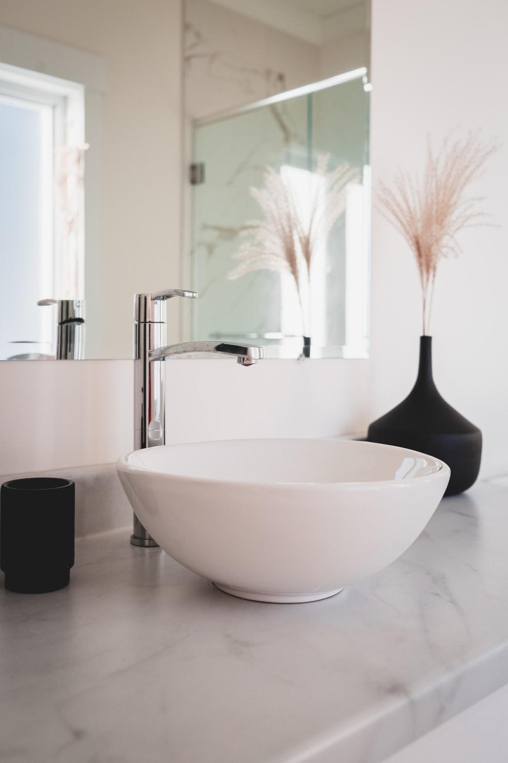 white ceramic bowl on black table