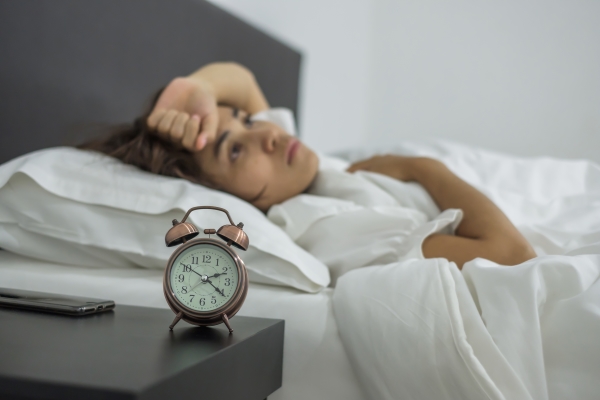 young-female-sleep-bedroom-insomnia-sleeping-worried-stressed