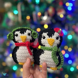 two crochet penguins with scarves and earmuffs