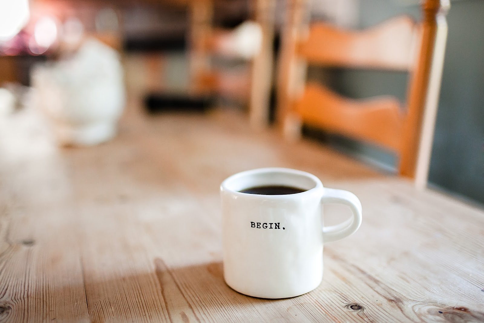 White ceramic mug on wooden table.