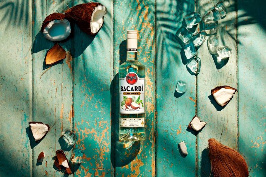 Bottle of bacardi with pieces of coconut