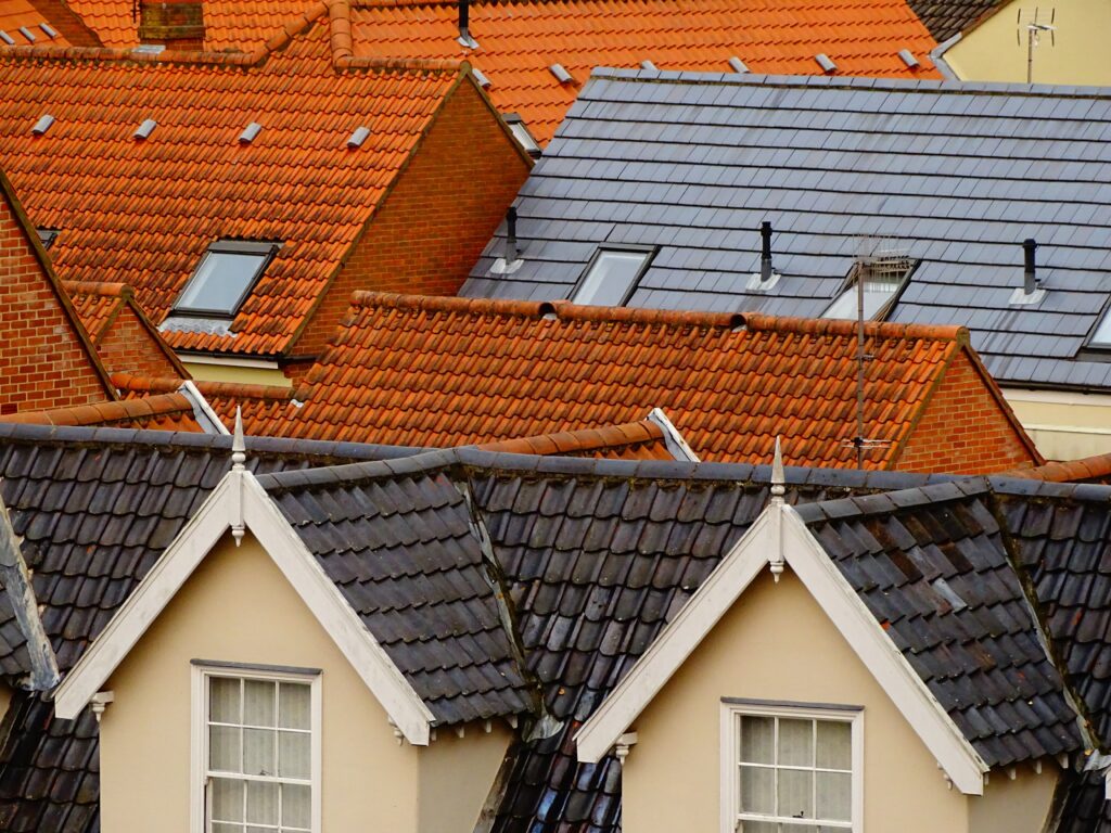 Tops of roofs with roof tiles on