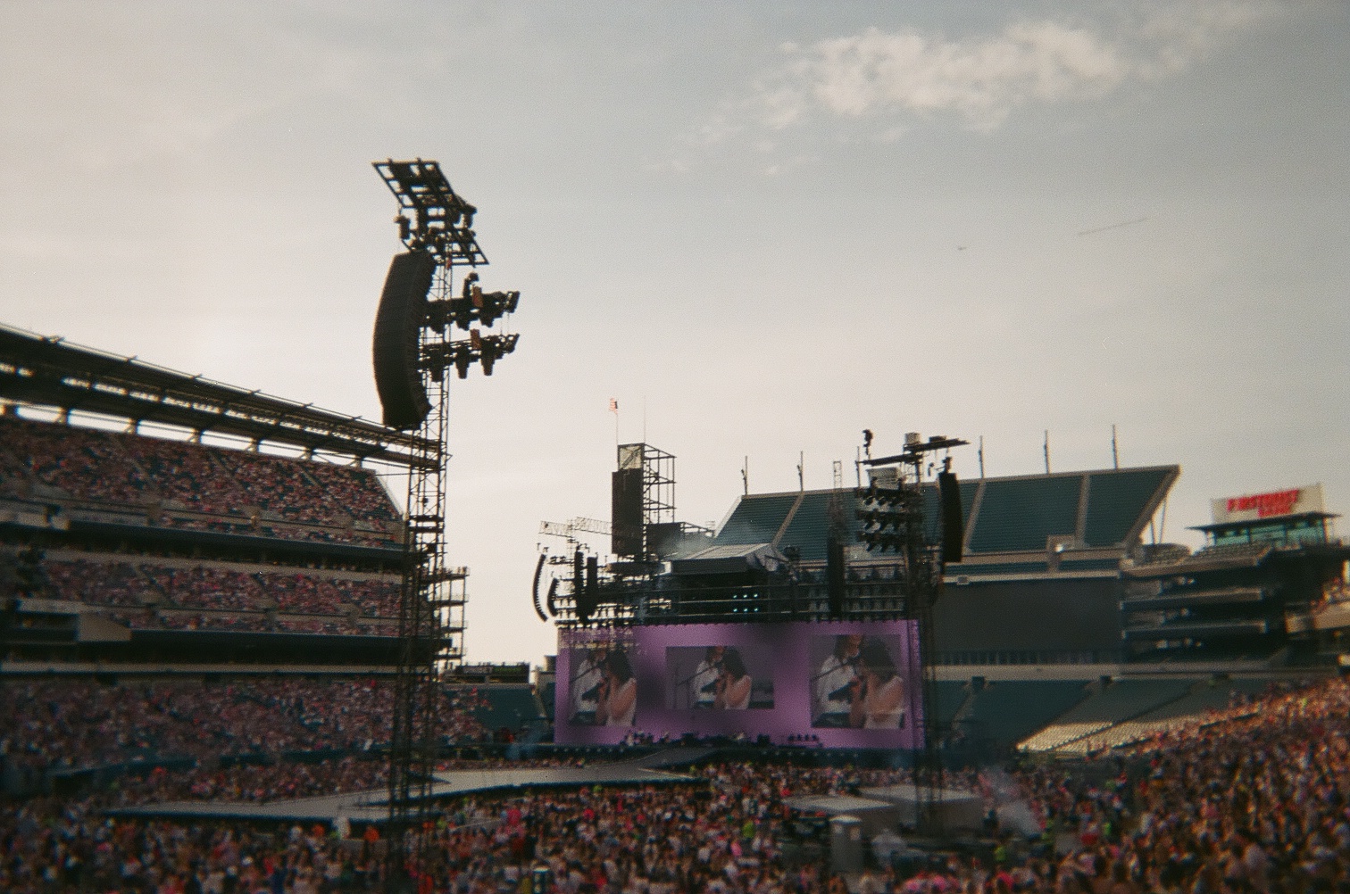 Stage with Gracie Abrams on the screen and a crowd filling the stadium.