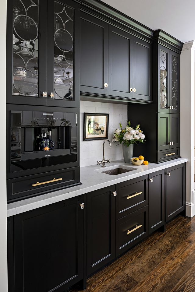 black shaker cabinets with custom espresso bar, white countertops and dark wood floors