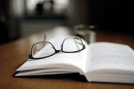 A pair of glasses on top of a book

Description automatically generated with medium confidence