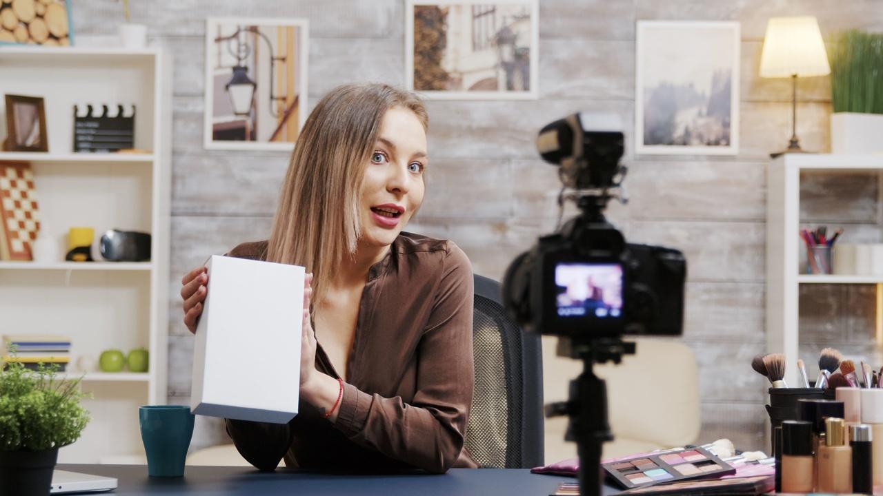 a vlogger introducing and promoting a product to a camera for her video