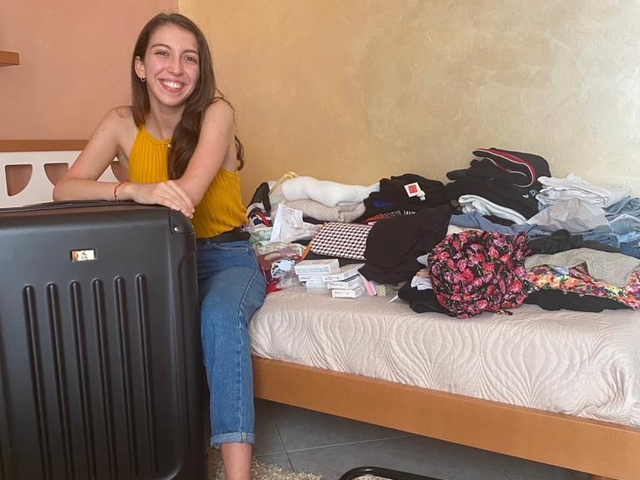 Italian exchange student packing her suitcase to go to the USA