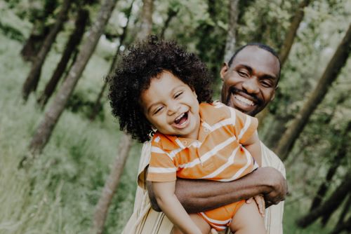 A smiling father and son after reading about the best credit repair companies. 