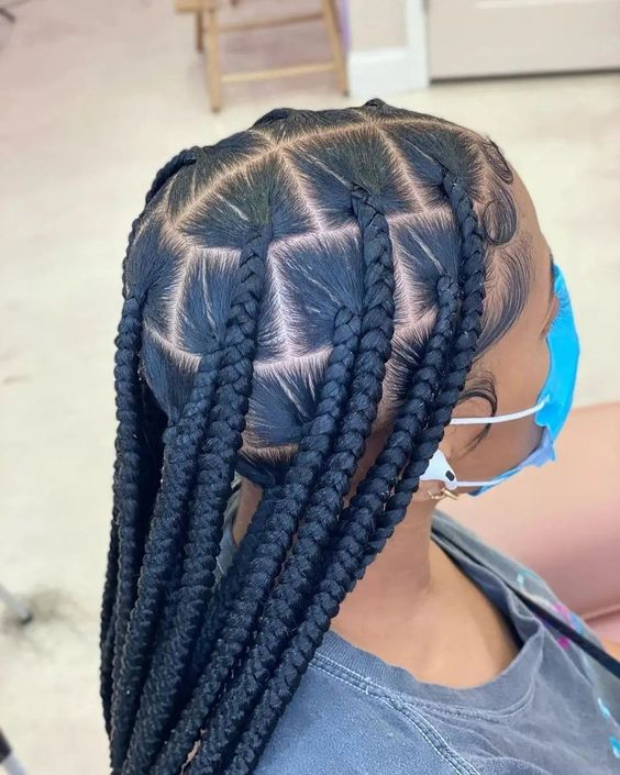 Another look of the lady on mask rocking her large knotless braids.