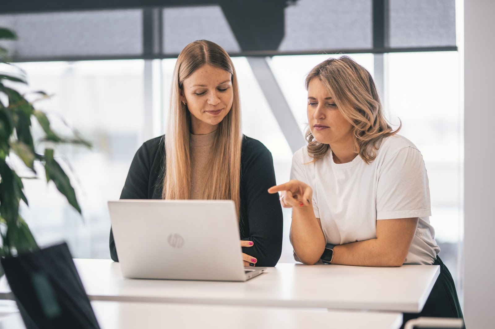 Two women in the office discussing work 