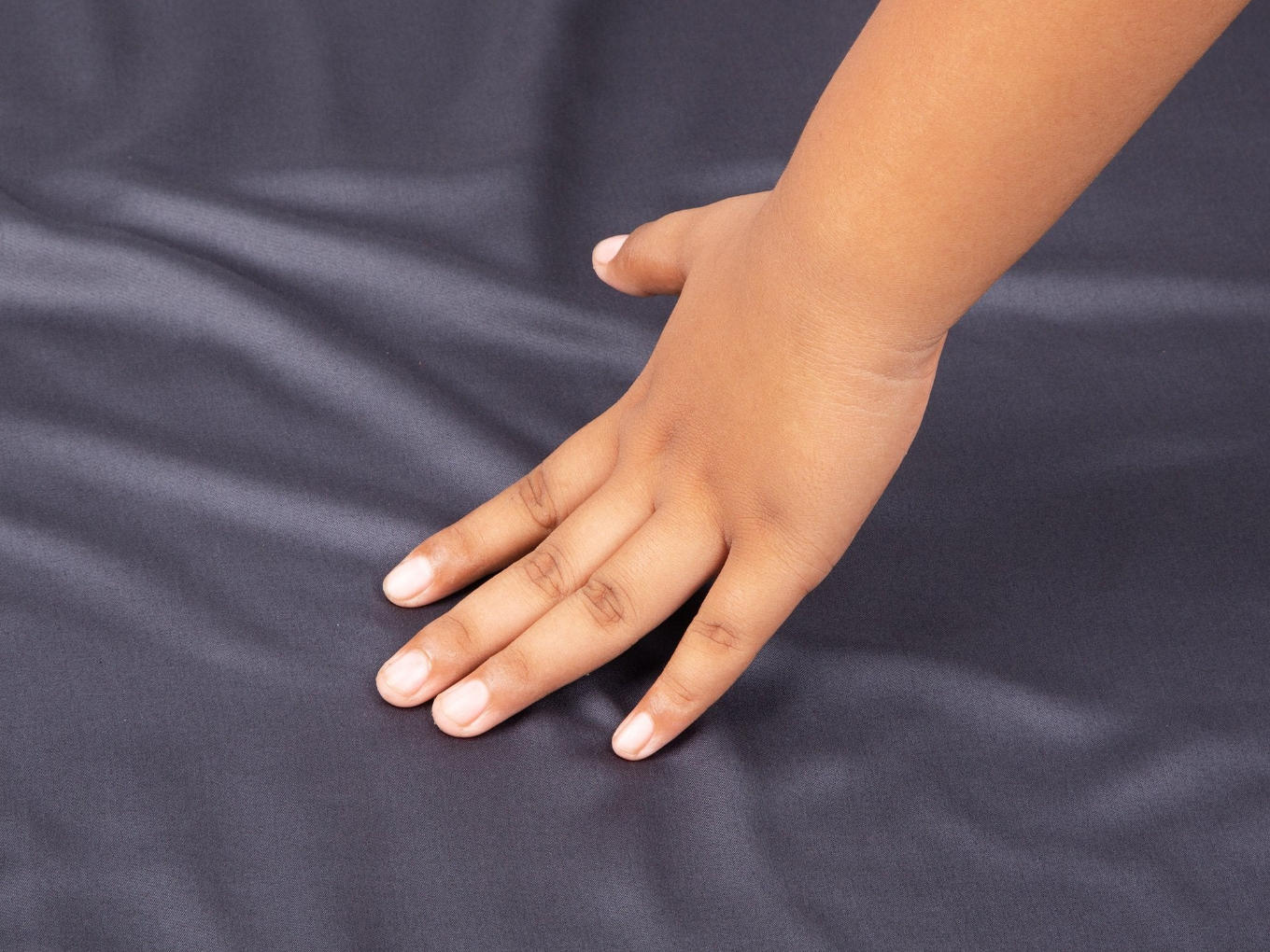 Hand brushing a dark grey sheet