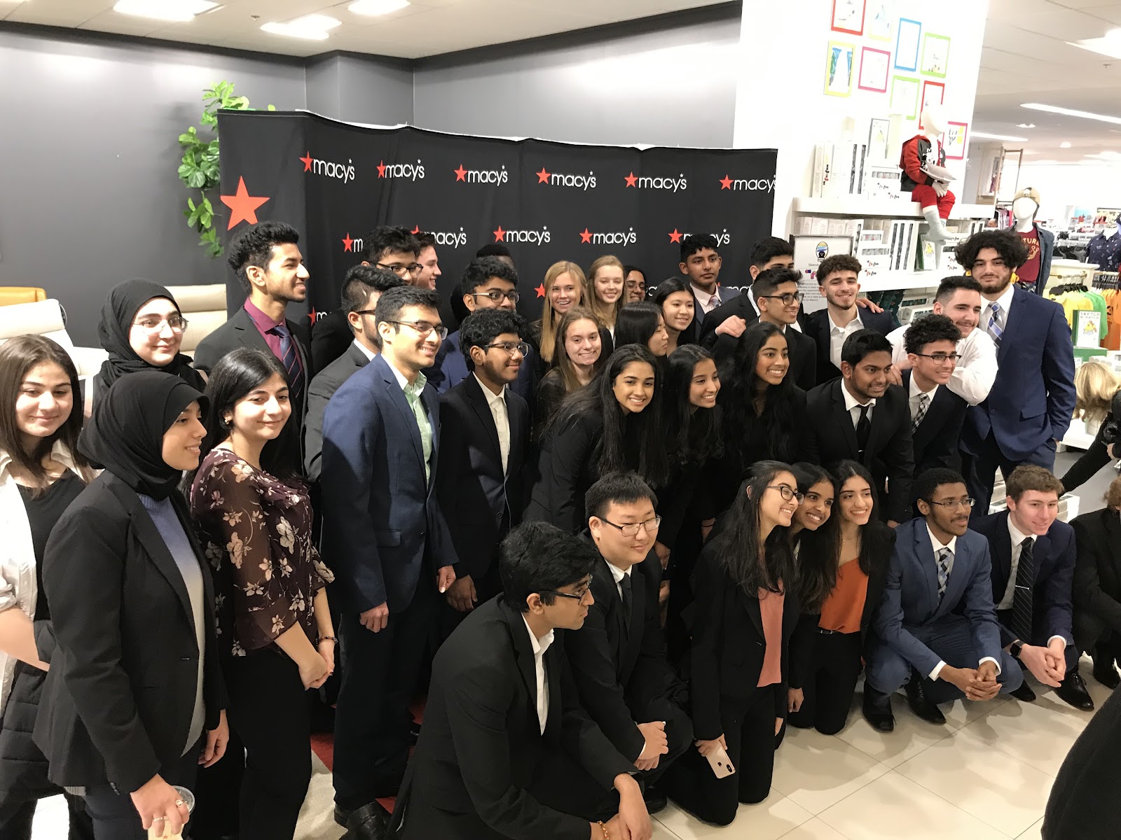 Fordson and Novi High School students taking an opportunity to pose for a photo together.