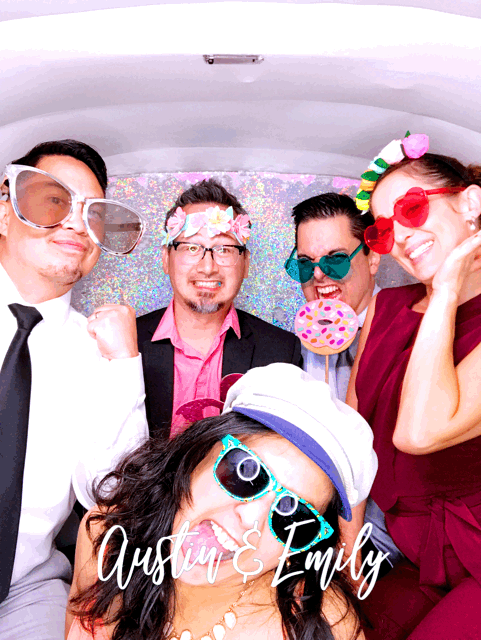 austin and emily's wedding party using a photo booth