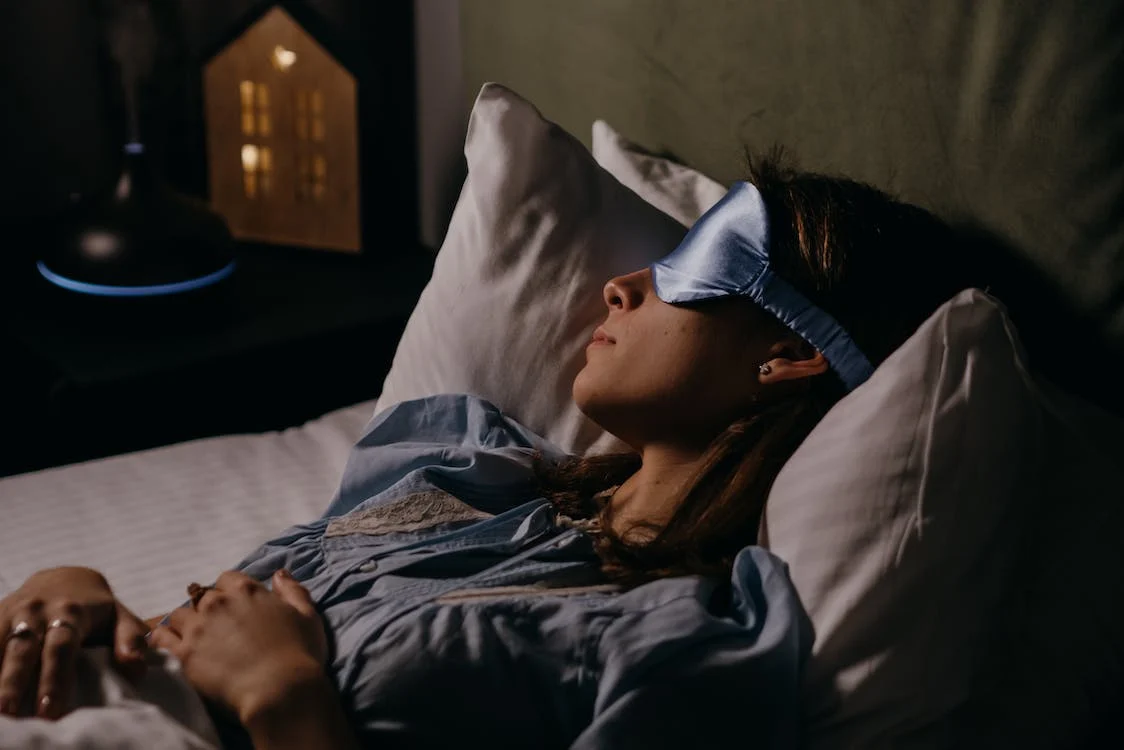 asleep woman wearing eye mask
