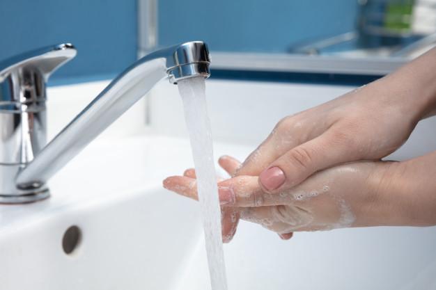 Woman washing hands carefully in bathroom close up. prevention of infection and flu virus spreading Free Photo